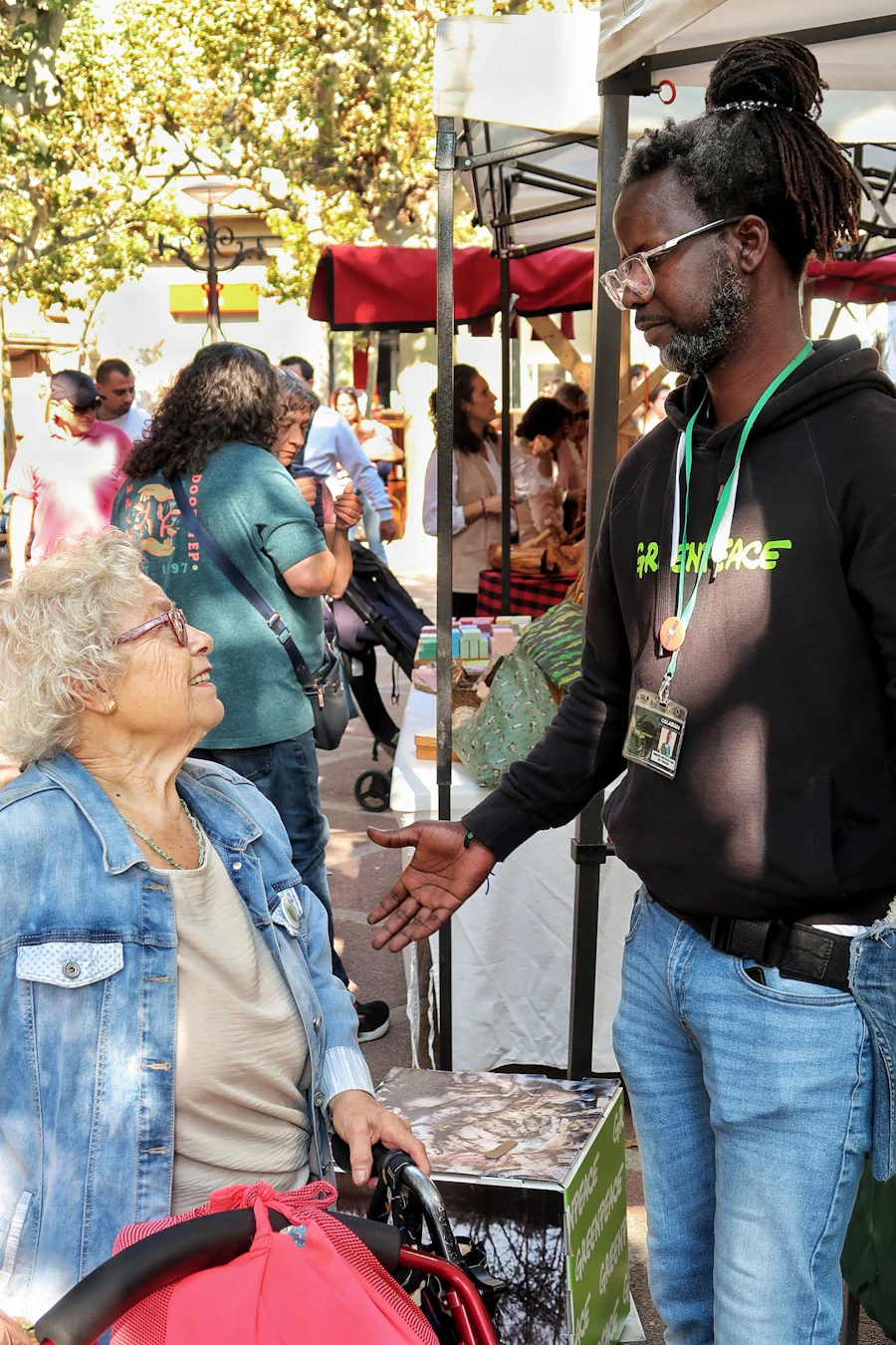 Two community members in conversation at an outdoor market