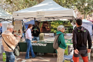 People at a greenpeace outdoor event booth