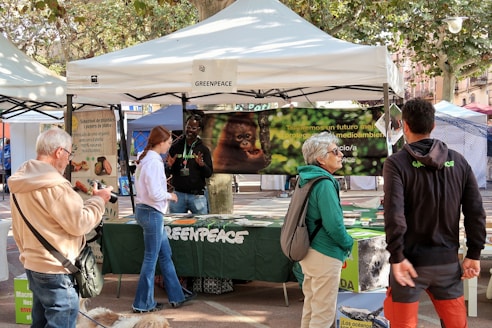 People at a greenpeace outdoor event booth