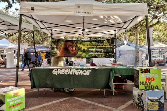 Greenpeace booth with environmental awareness signs