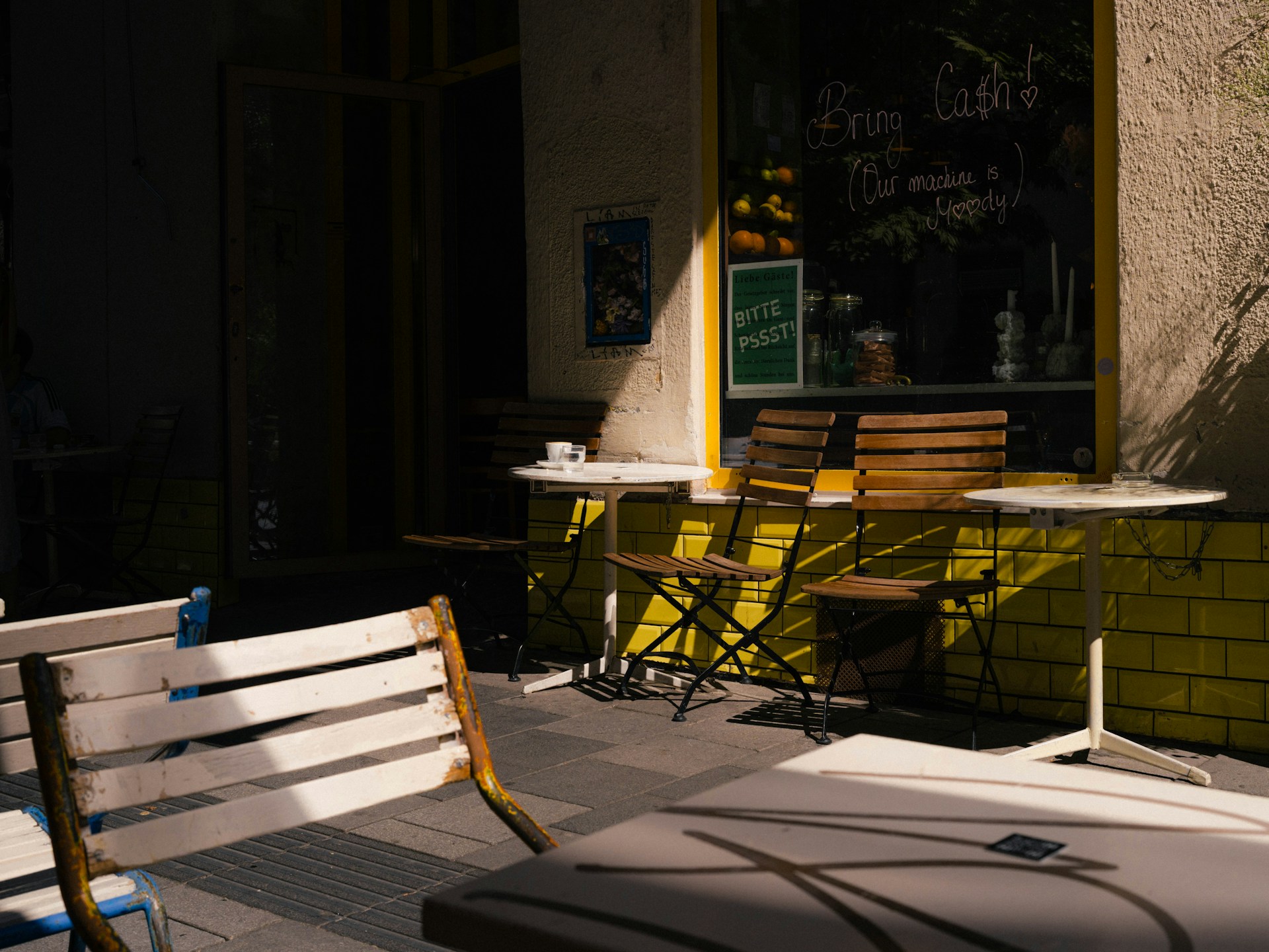 Outdoor cafe seating bathed in sunlight