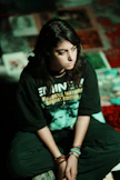 Young woman in eminem t-shirt sits on floor
