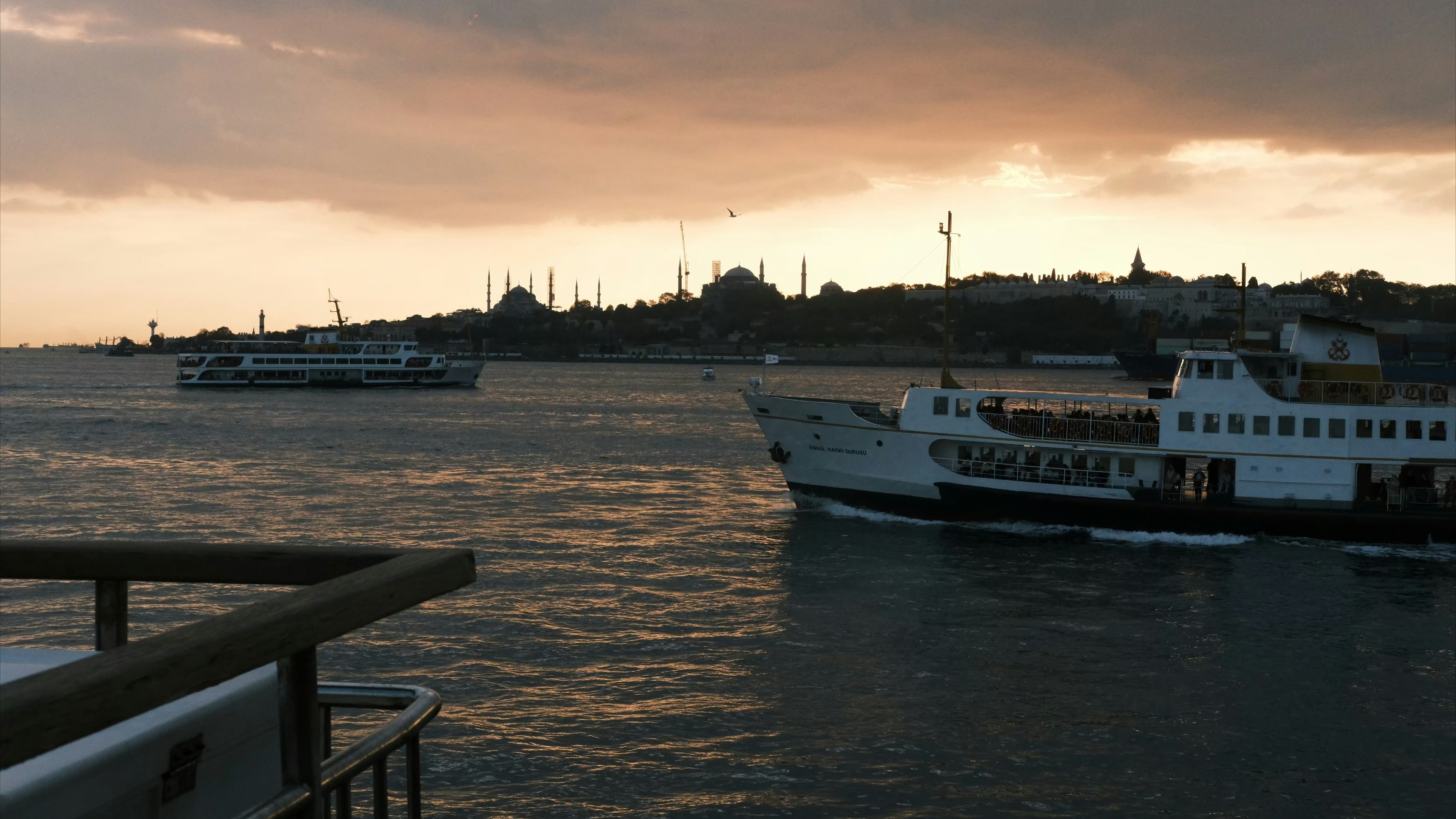 Ferries sail across the bosphorus at sunset