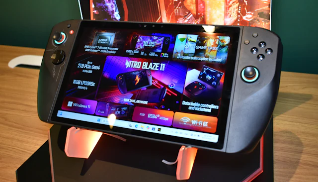 A handheld gaming console lit by a colourful game screen