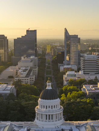 California state capitol building with city skyline at sunset