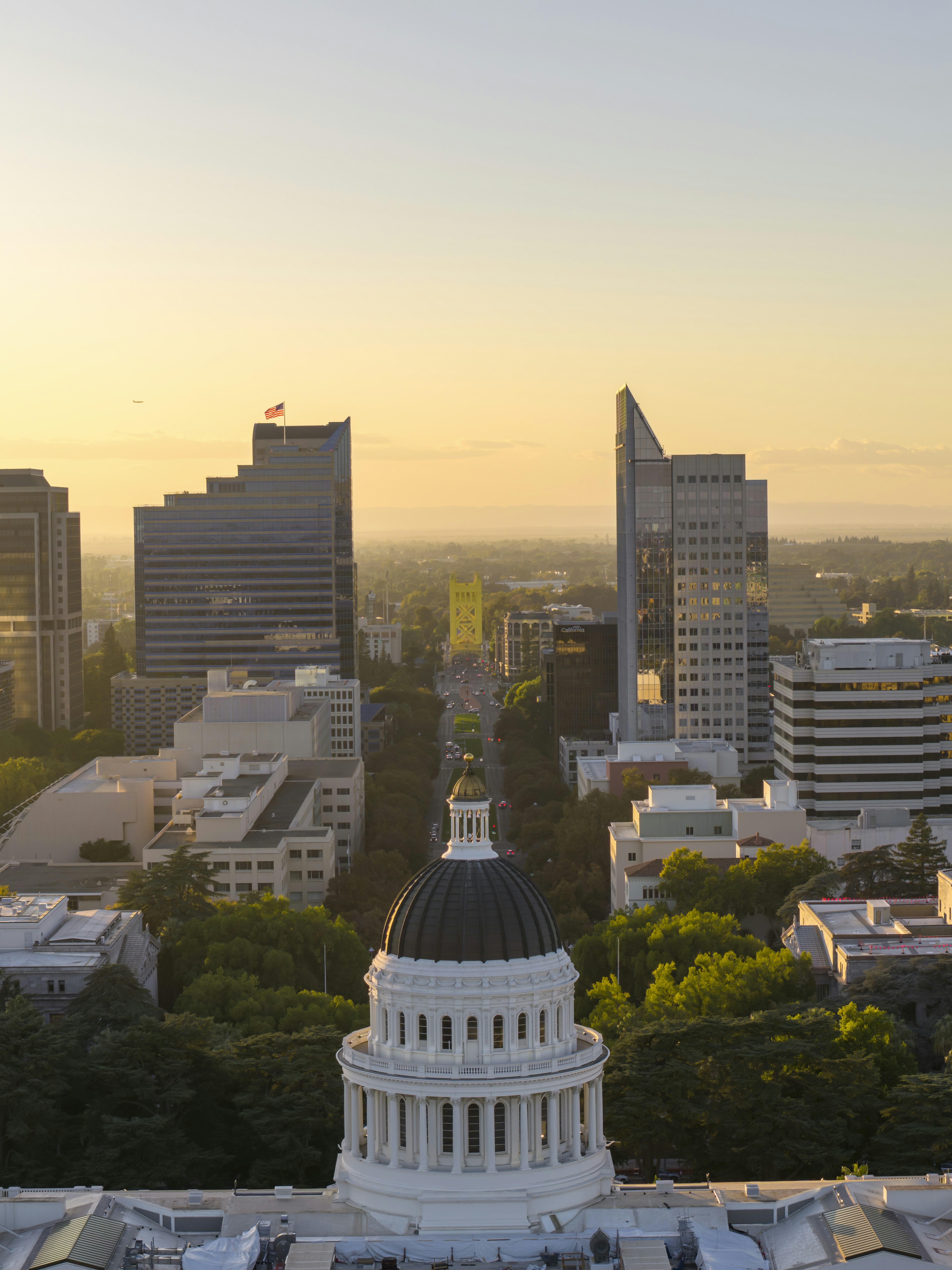 California state capitol building with city skyline at sunset