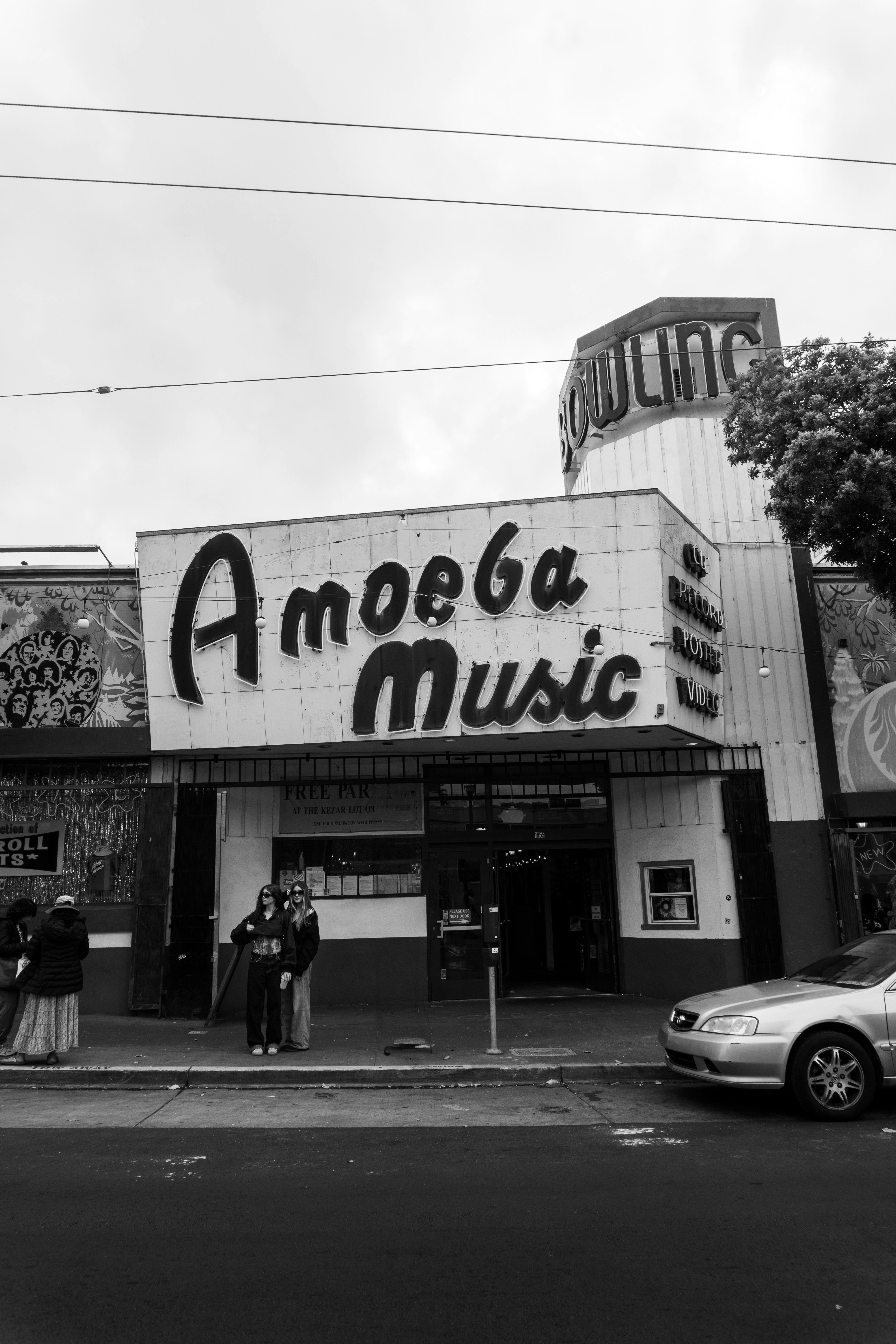 Amoeba music store facade with people and car