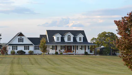 White farmhouse with a wrap-around porch