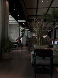 Modern cafe interior with plants and seating areas