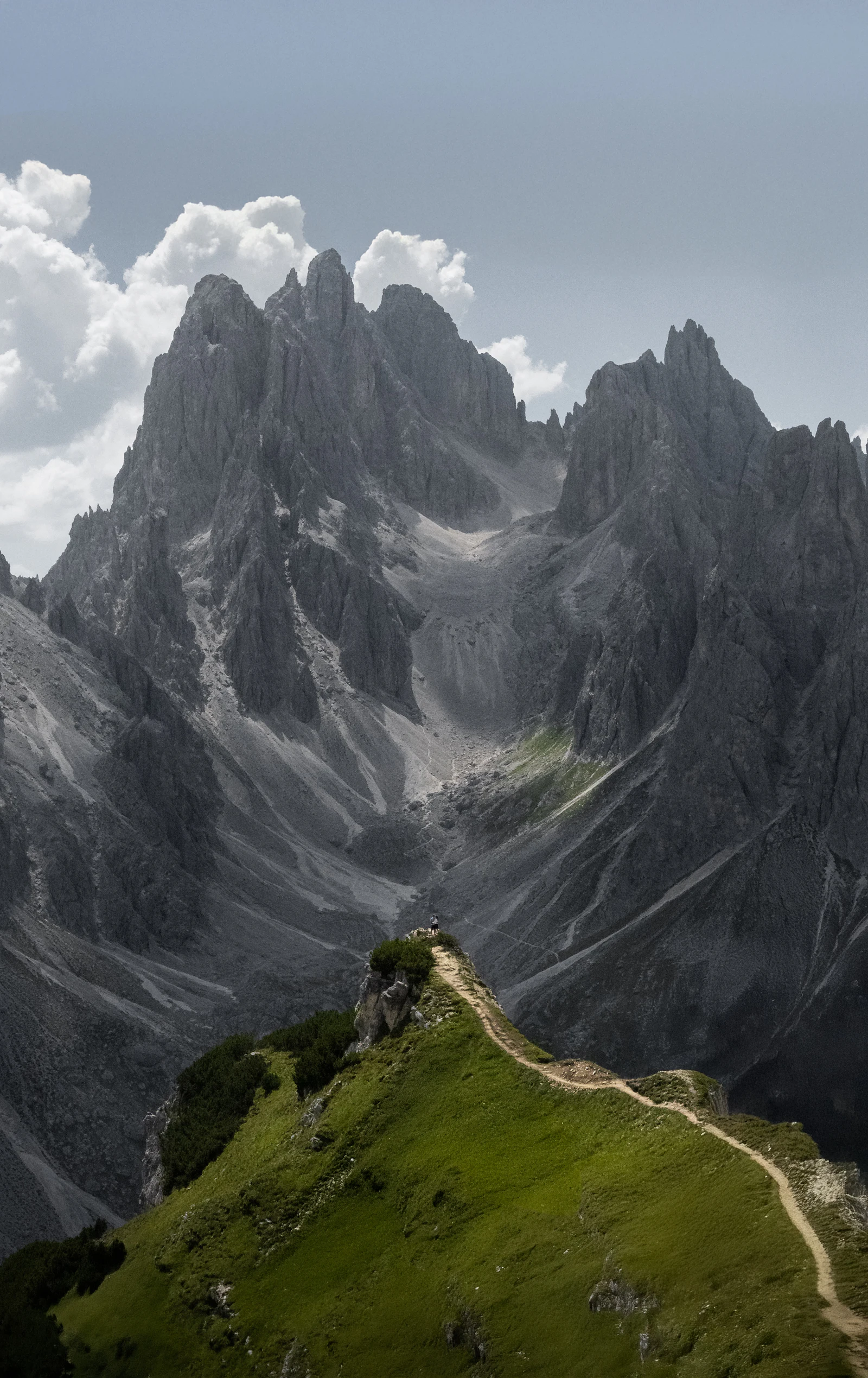 Sentier de montagne serpentant vers des sommets rocheux — image d'illustration