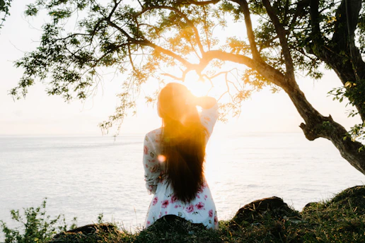 Woman in sunlight by the ocean
