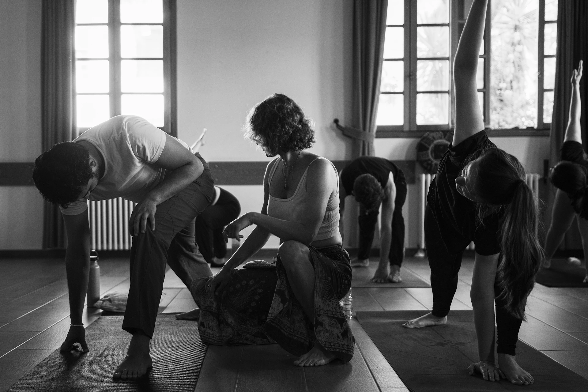 Yoga instructor assisting student in class
