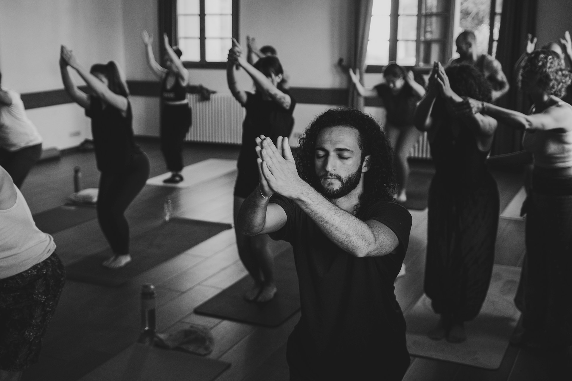 People practicing yoga in a studio class.