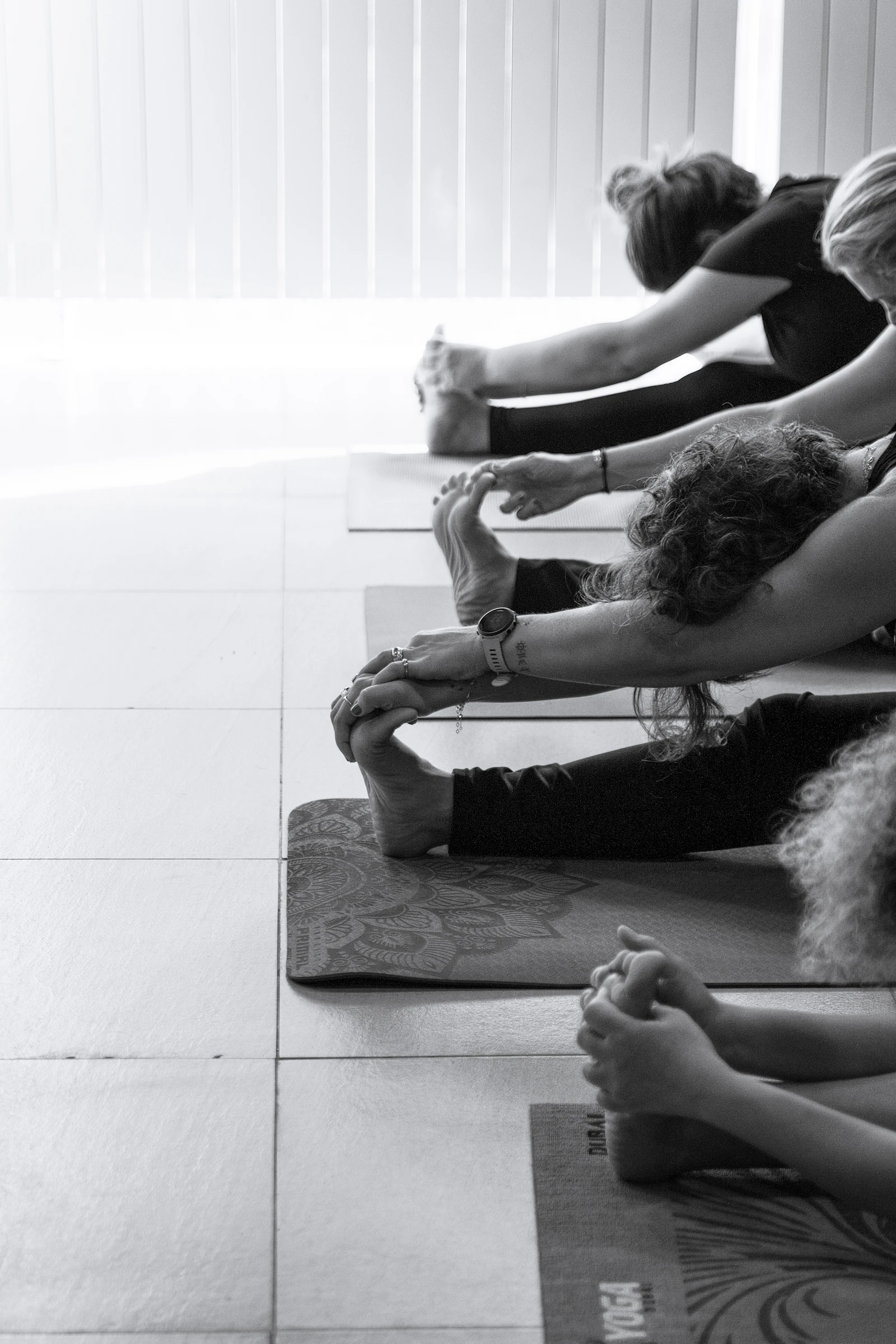 Students stretching on yoga mats through a morning class in the shala