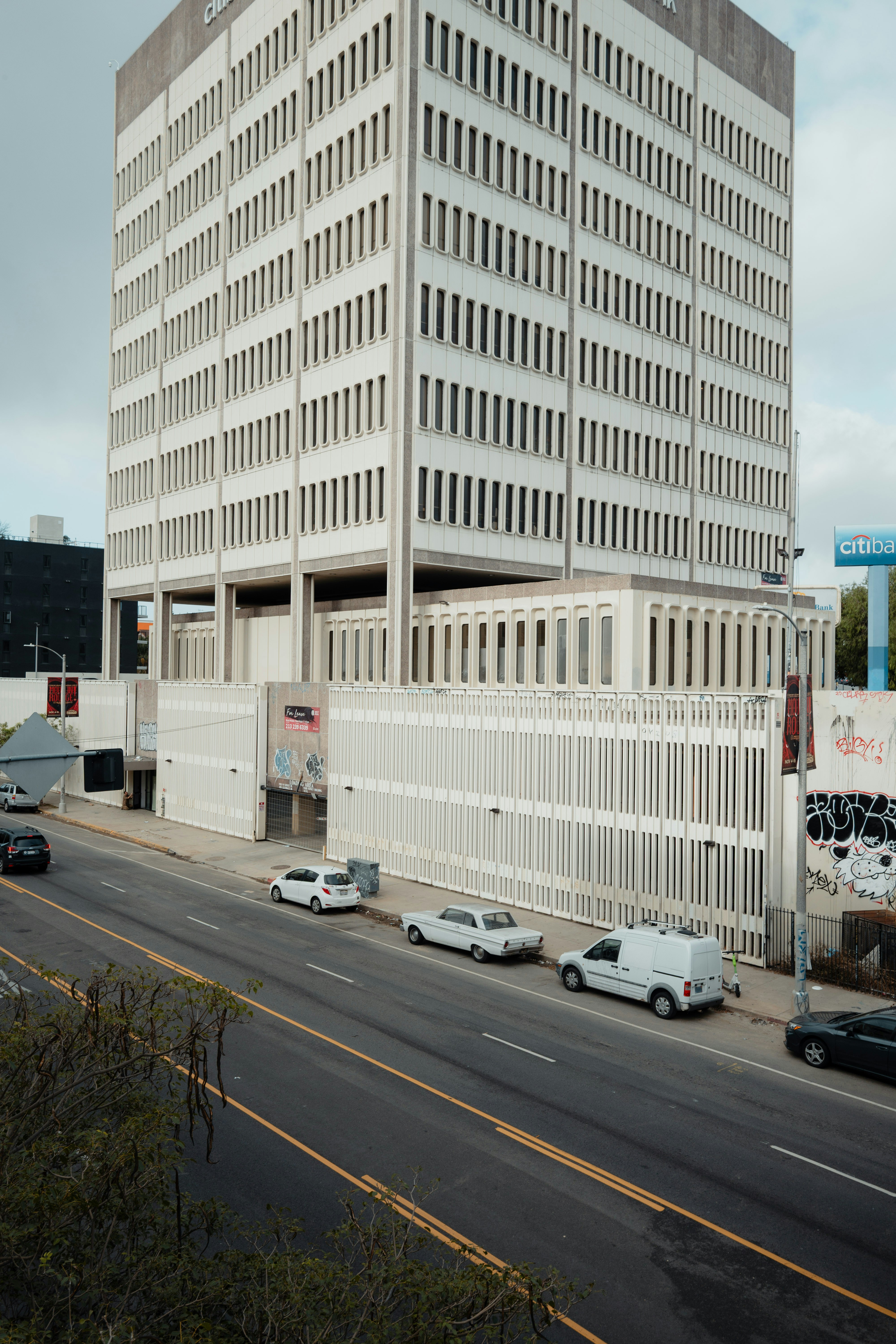 White building with cars on street
