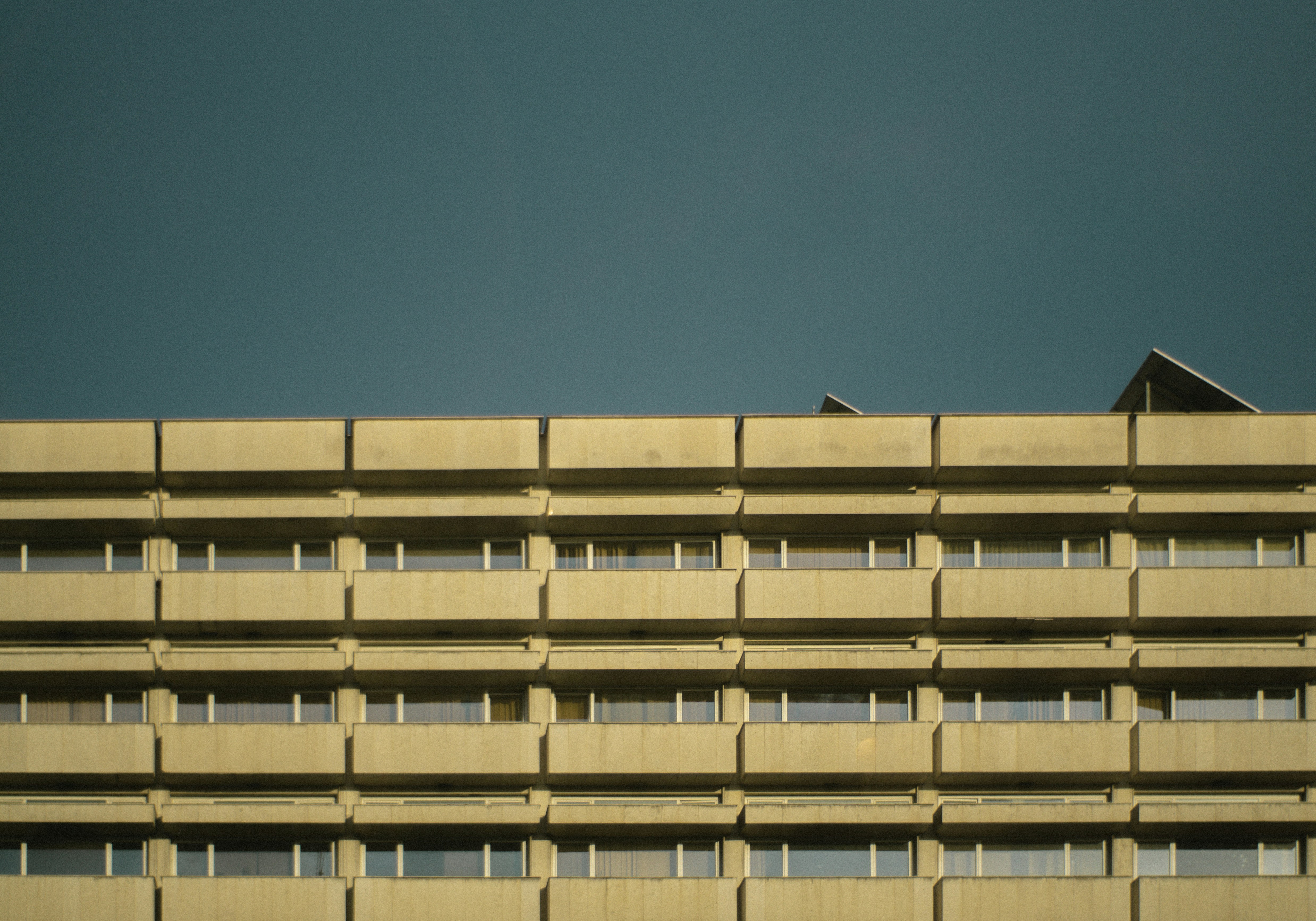 A brutalist building facade under a dark sky