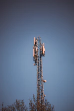 Cellular tower against a clear blue sky.