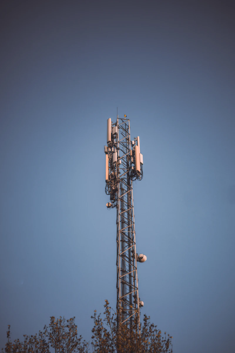 A cellular tower against a clear blue sky