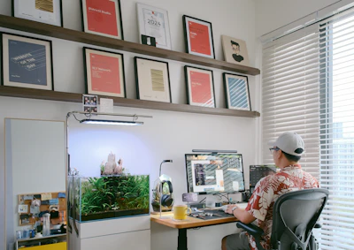 Man working at a desk with an aquarium.