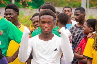 Young man in white shirt with friends watching