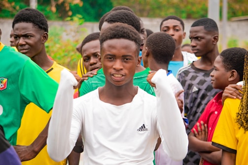 Young man in white shirt with friends watching