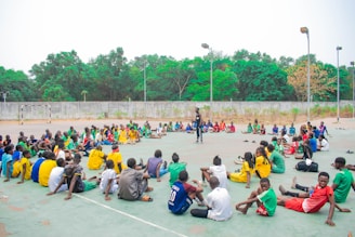 Group of people sitting in a circle outdoors.