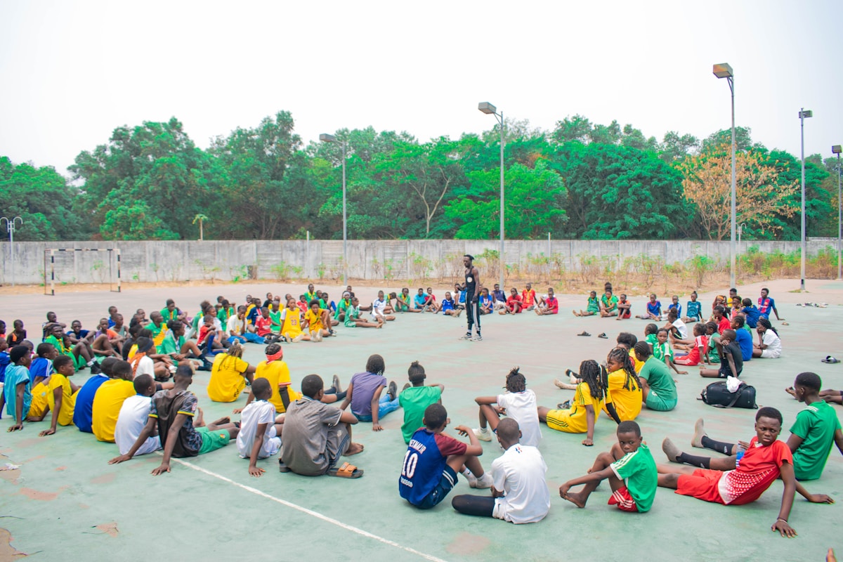 Group of people sitting in a circle outdoors.