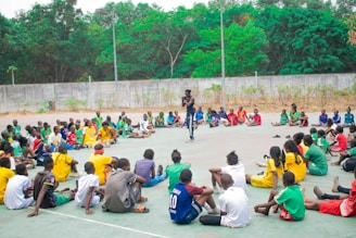 Man addresses group of people sitting in a circle.