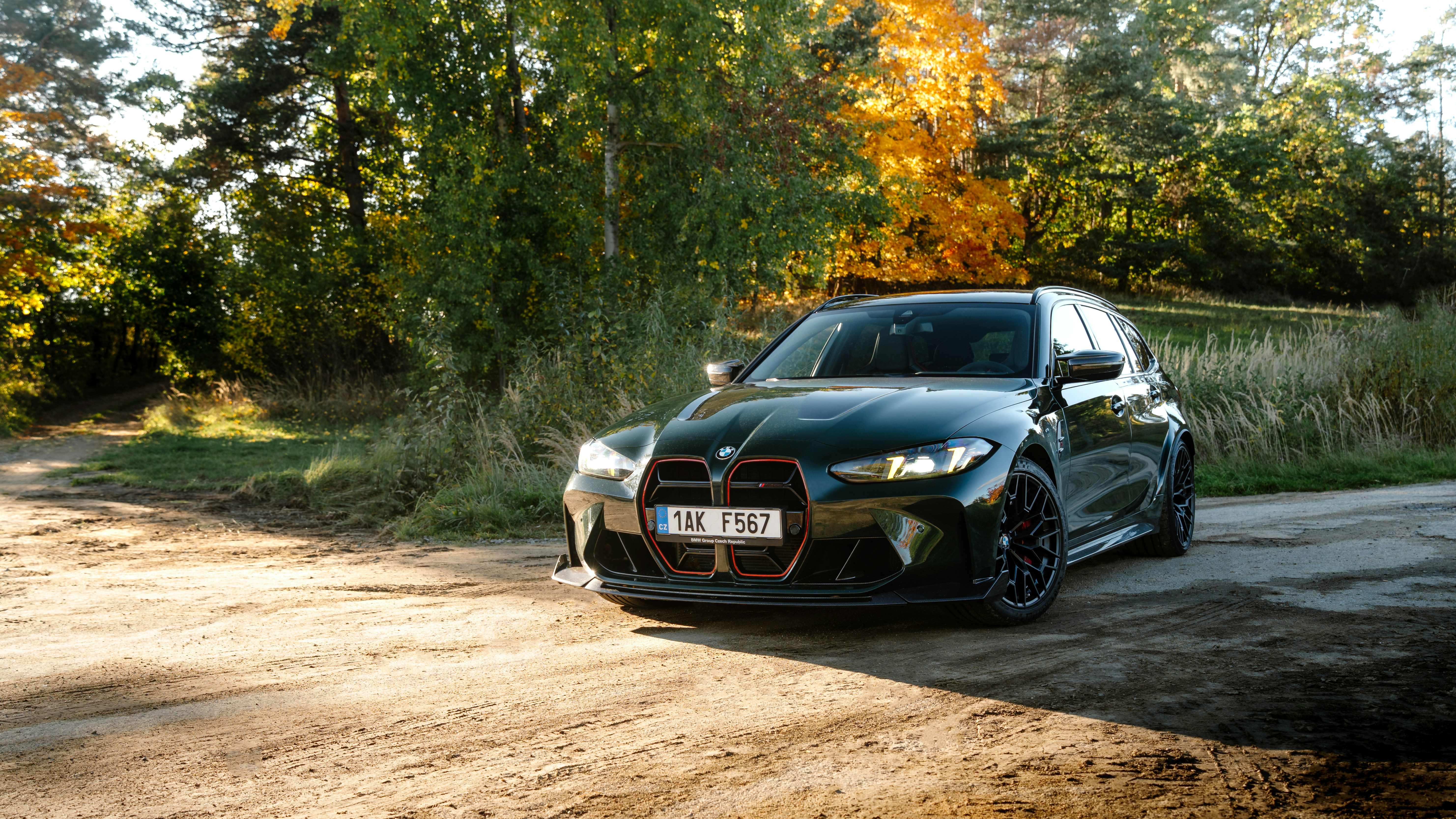 Black BMW m car parked on a dirt road