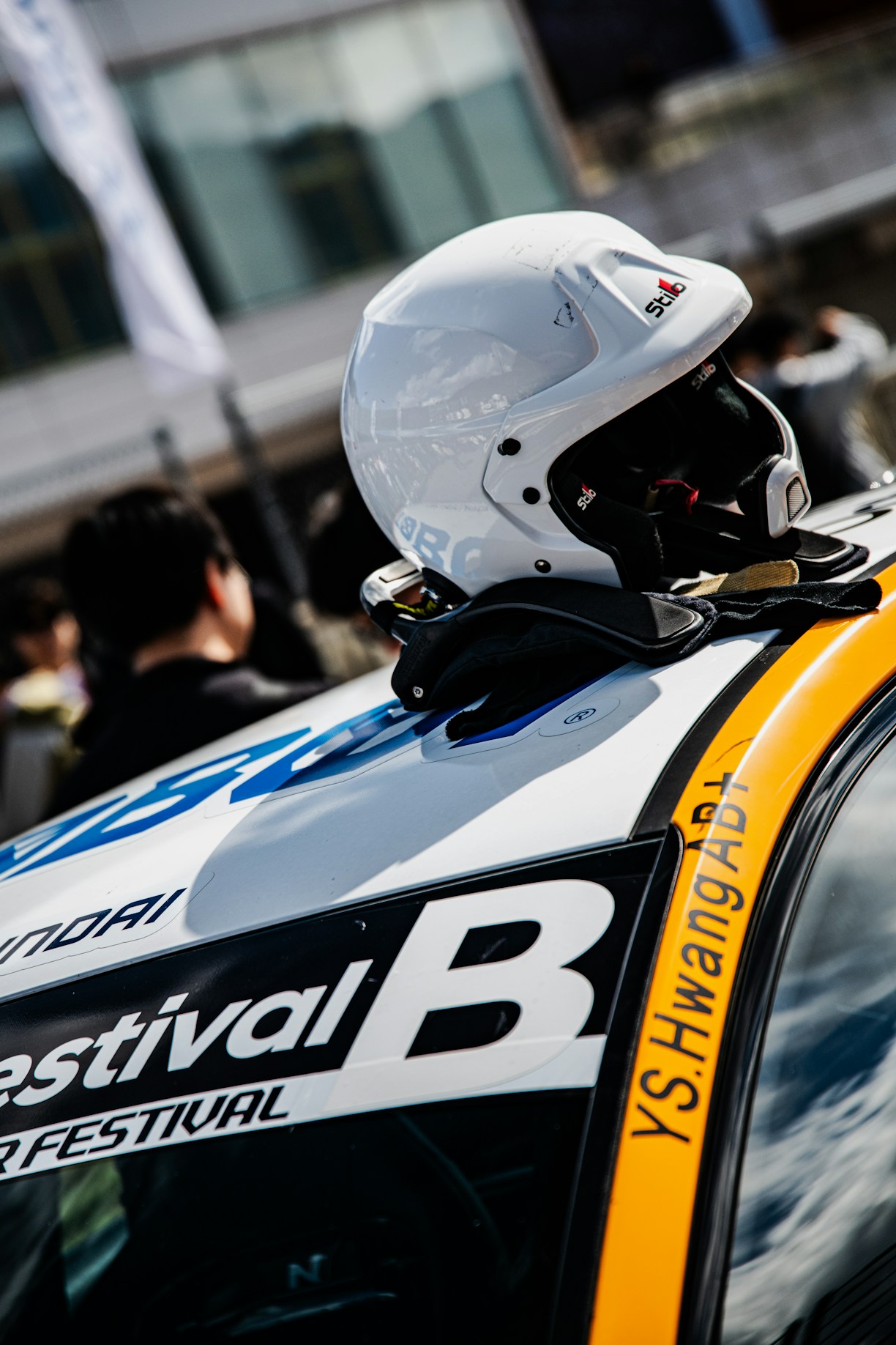 White racing helmet rests on a car