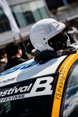 White racing helmet rests on a car