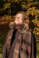 Woman enjoying sunlight in autumn forest