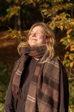 Woman enjoying sunlight in autumn forest