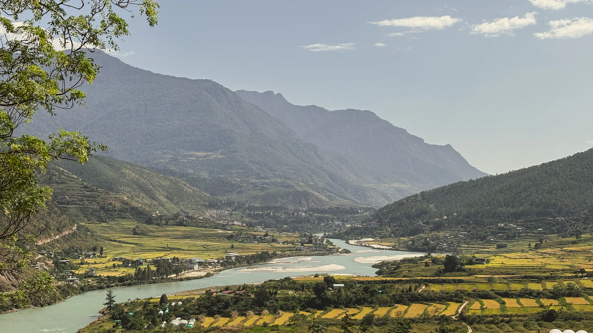 A river flows through a valley with mountains.