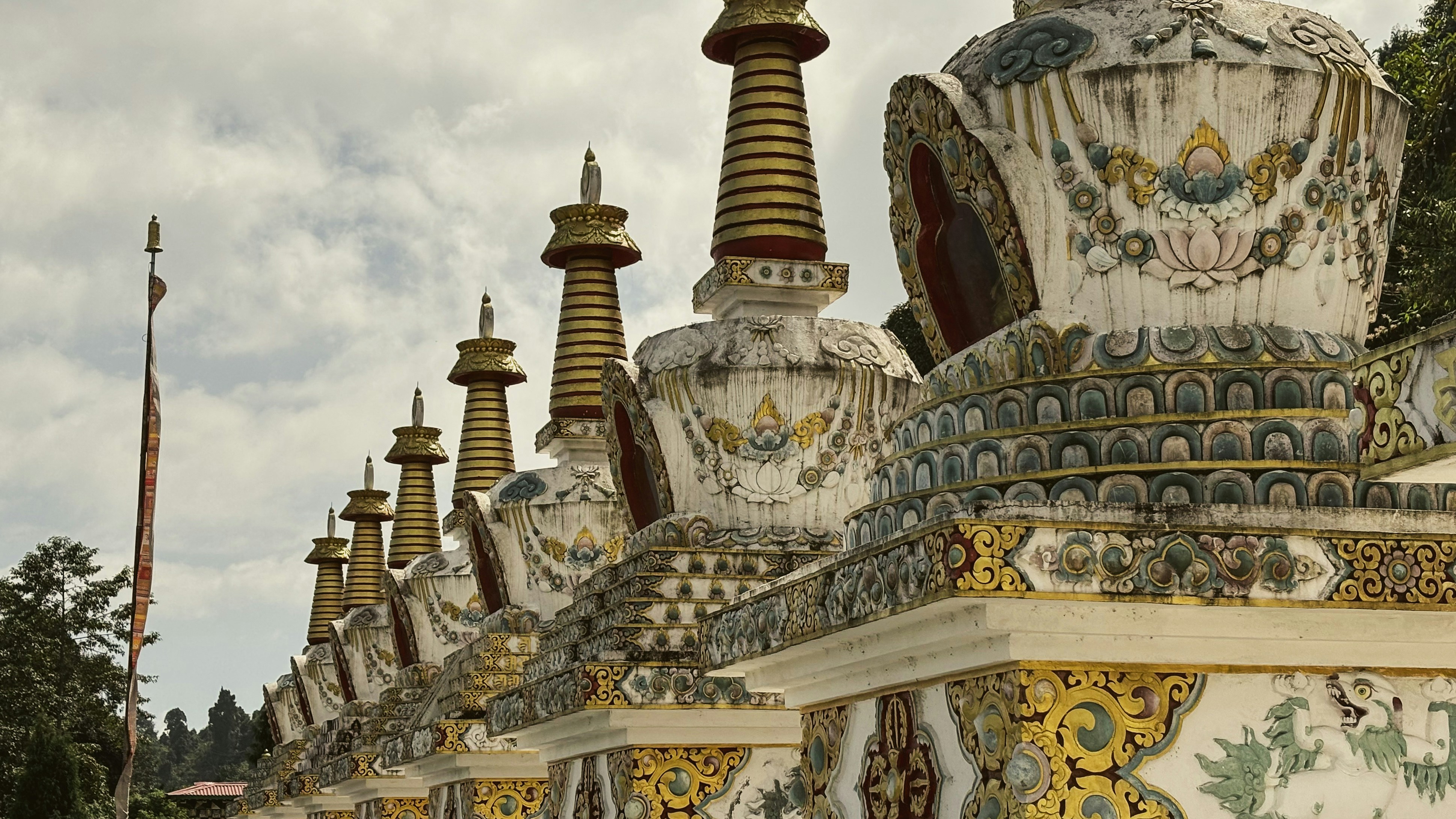 Row of ornate stupas with golden spires