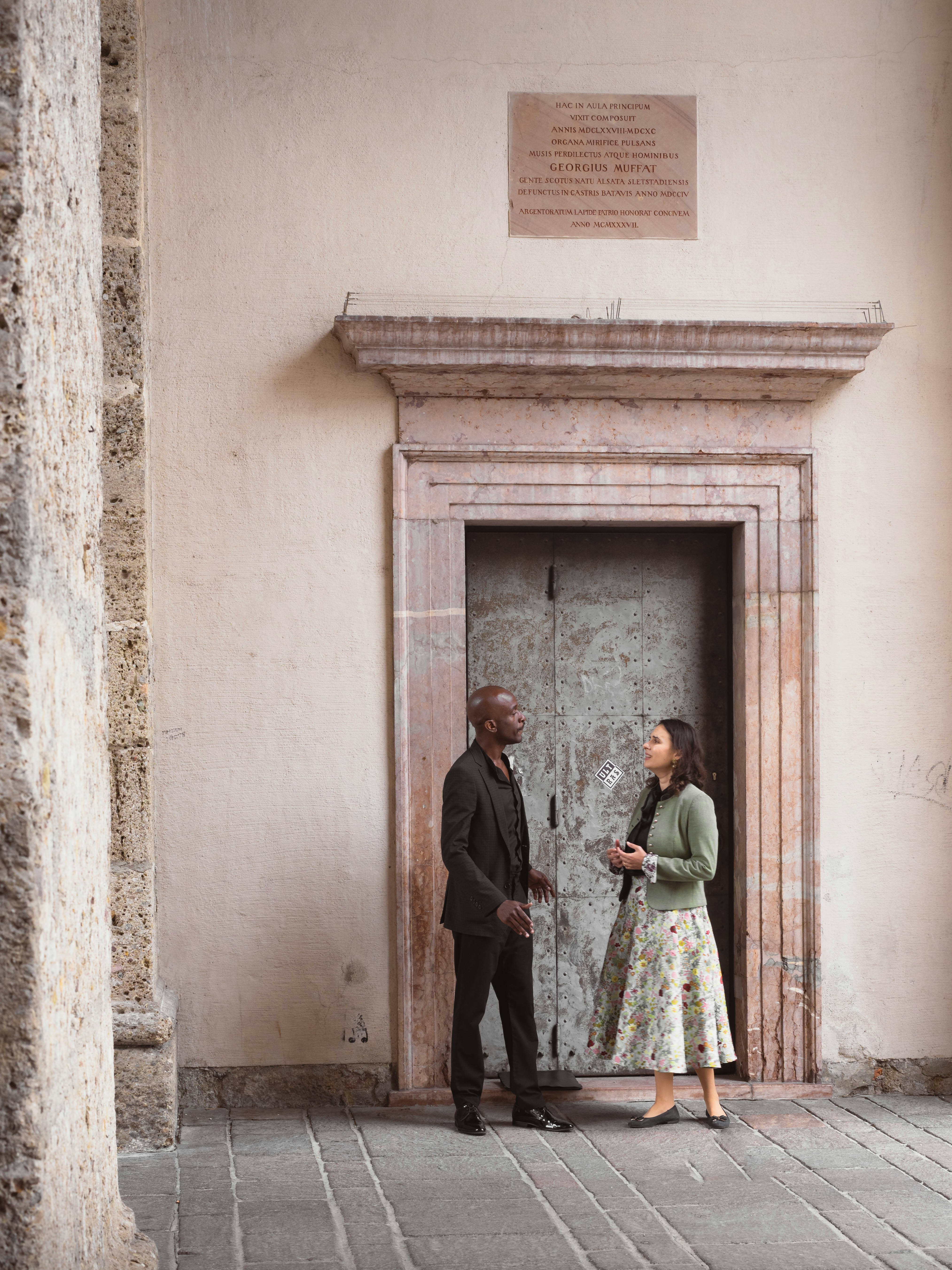 Couple standing in front of an ornate doorway