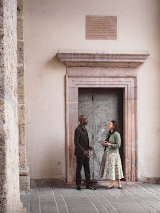 Couple standing in front of an ornate doorway