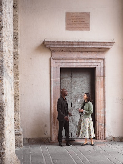 Couple standing in front of an ornate doorway