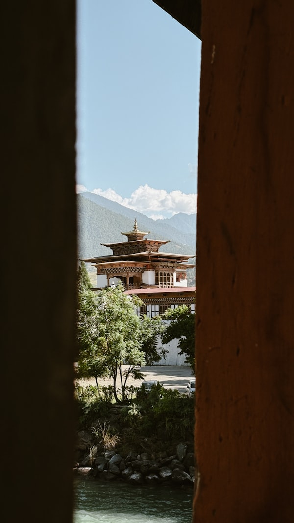 Punakha Dzong fortress monastery beside the river with Himalayan peaks in Bhutan