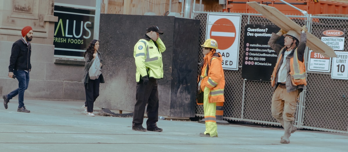 Construction workers at a building site - workplace where mandatory PPE safety signs are required