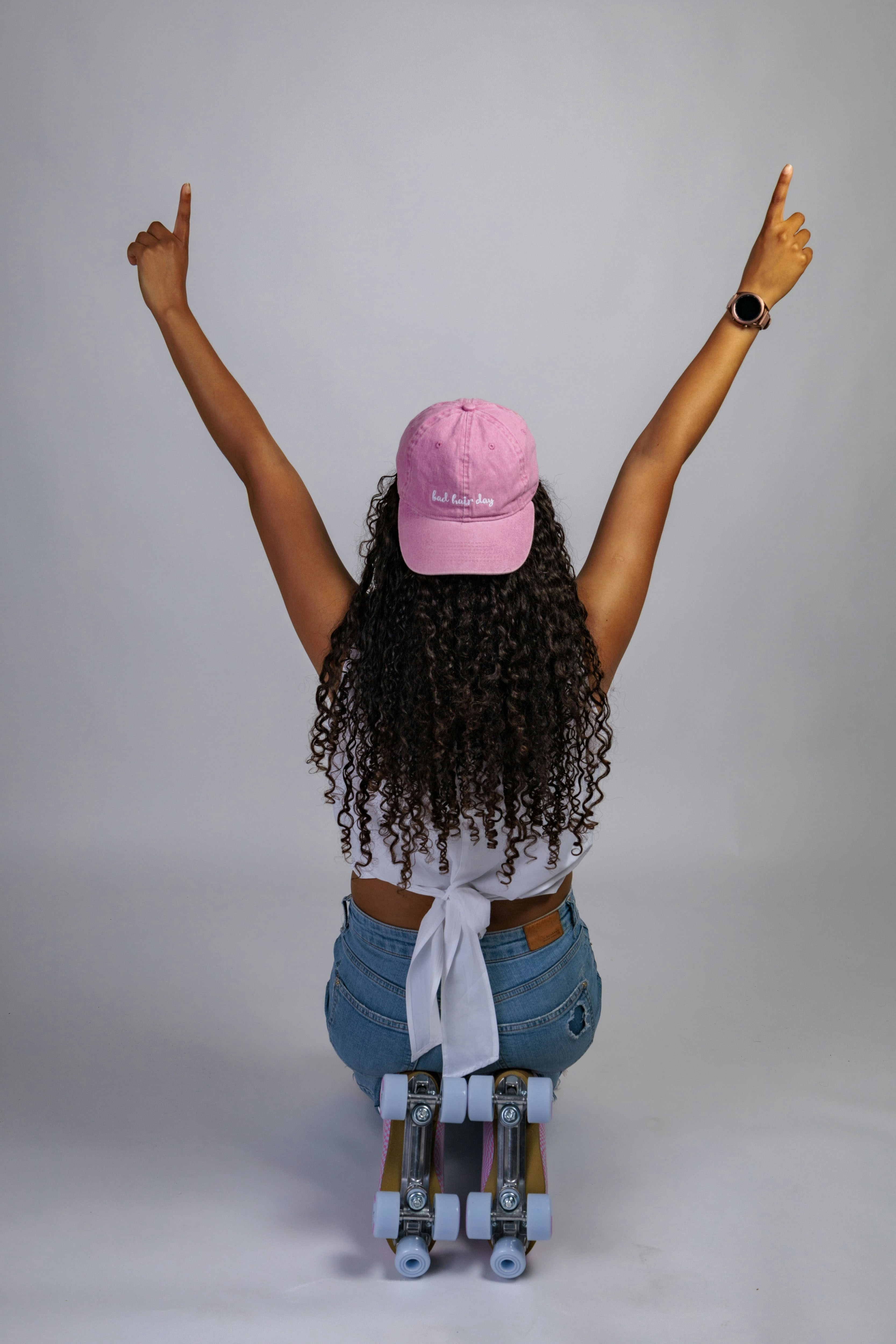 Woman with arms raised on roller skates
