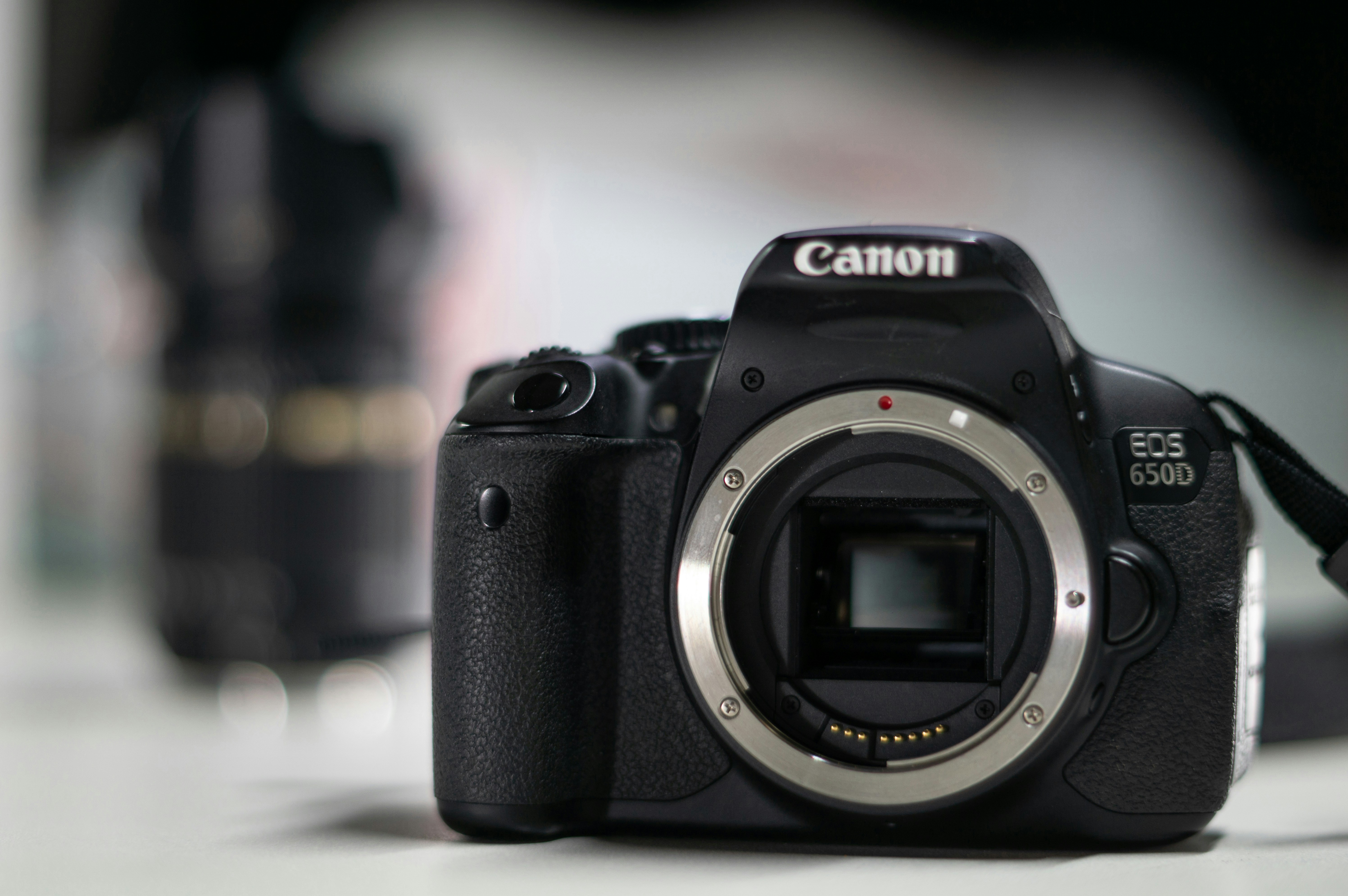 A black canon dslr camera without a lens.