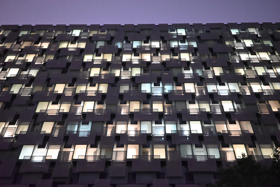 A building facade with lit windows at dusk