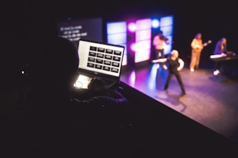 Musicians performing on stage with laptop control