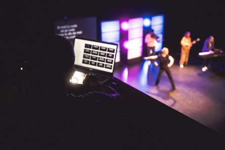 Musicians performing on stage with laptop control