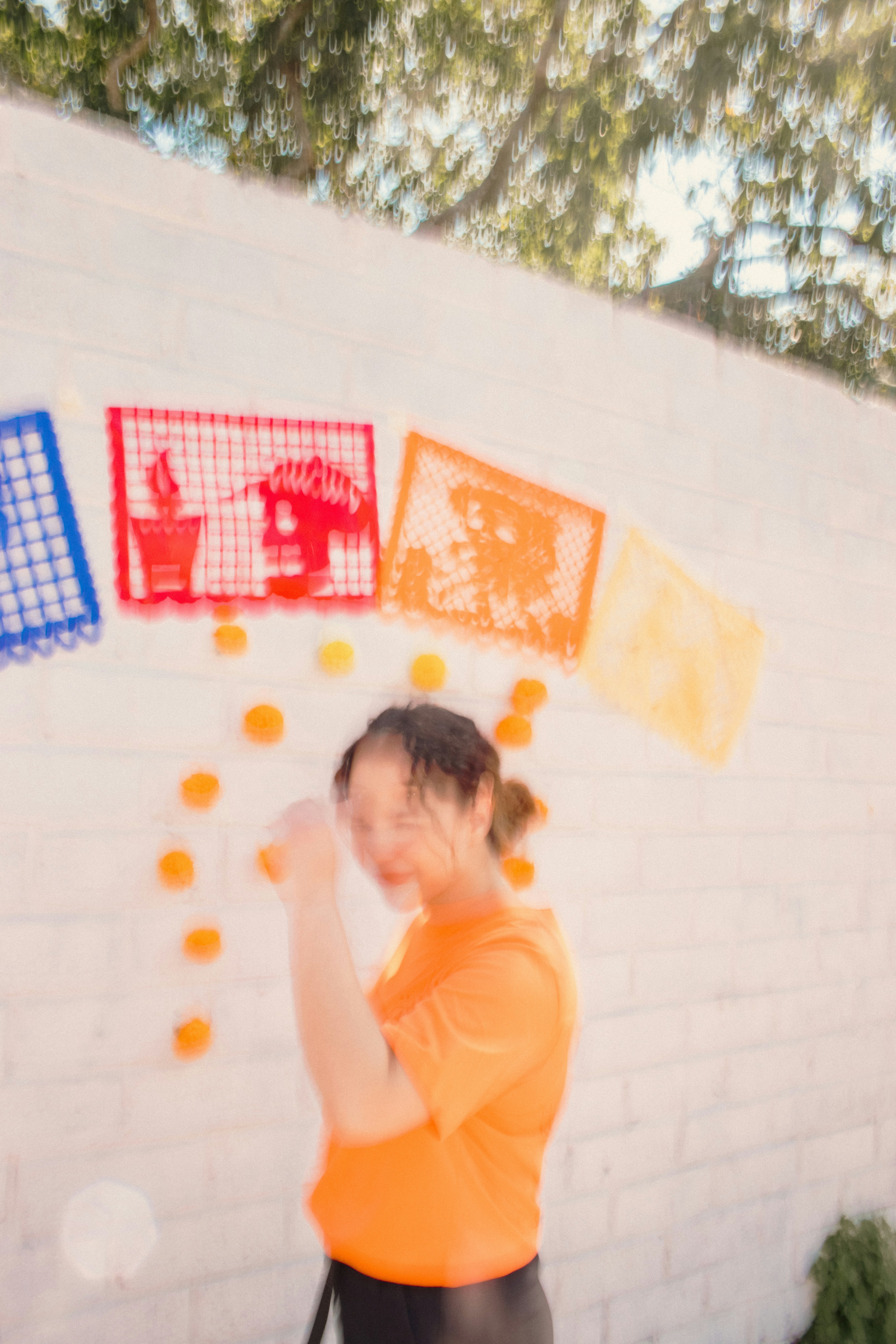 Woman in orange shirt with festive decorations