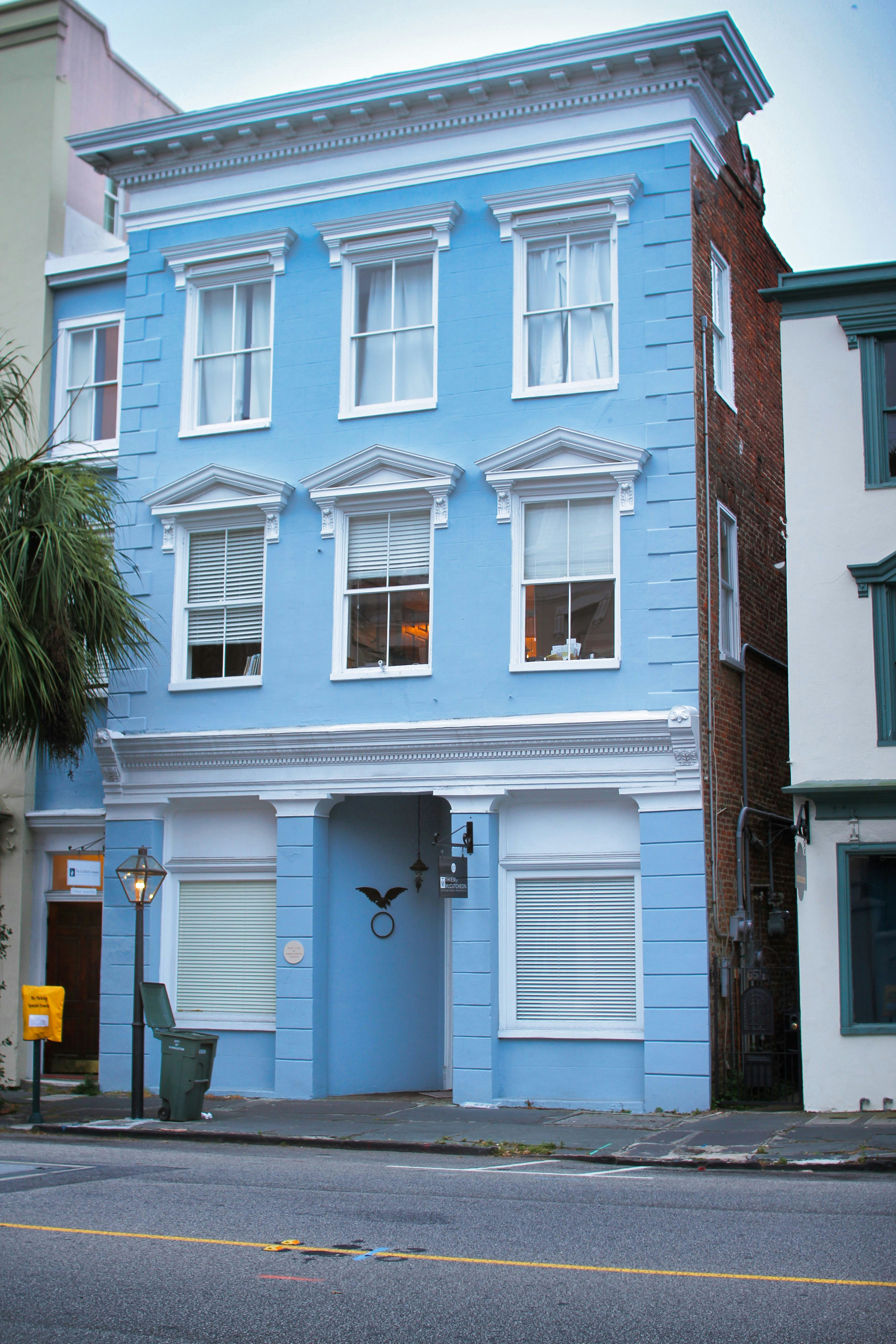 Victorian house showing bright blue and red paint scheme