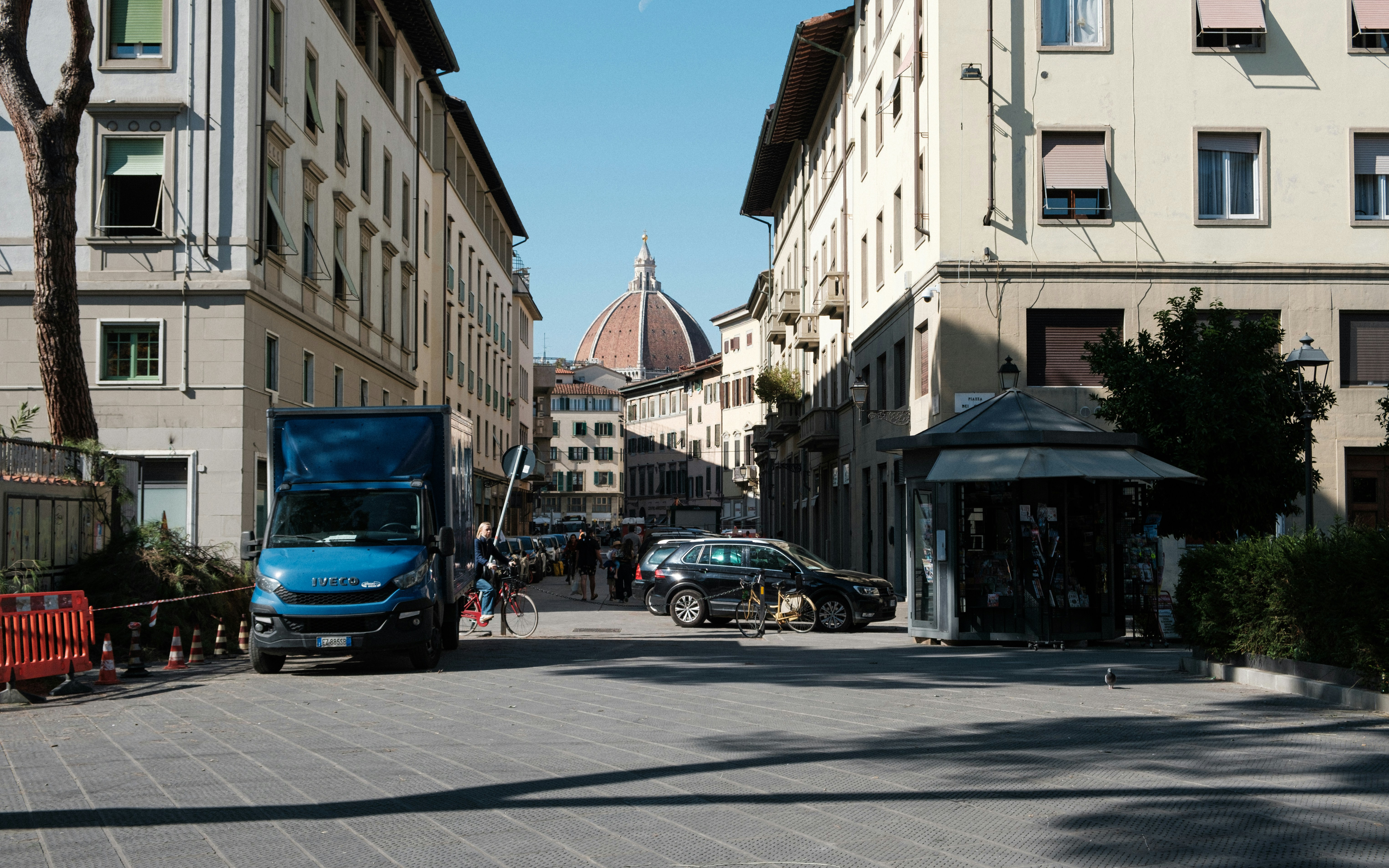 Street view with buildings and a dome in the distance