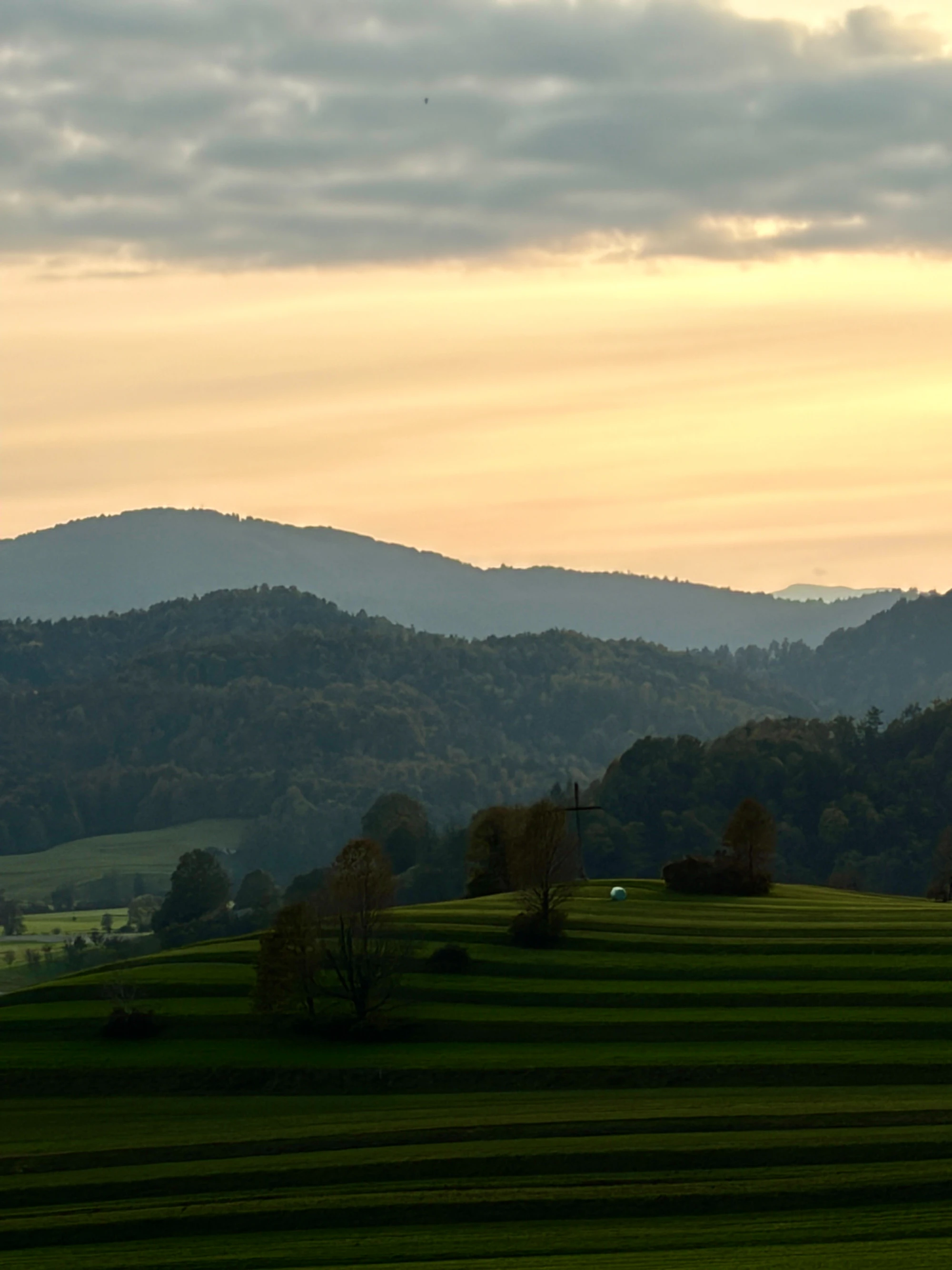 Layered ridgelines above a green valley at golden hour, similar to the Tennessee Valley terrain around Huntsville, Alabama