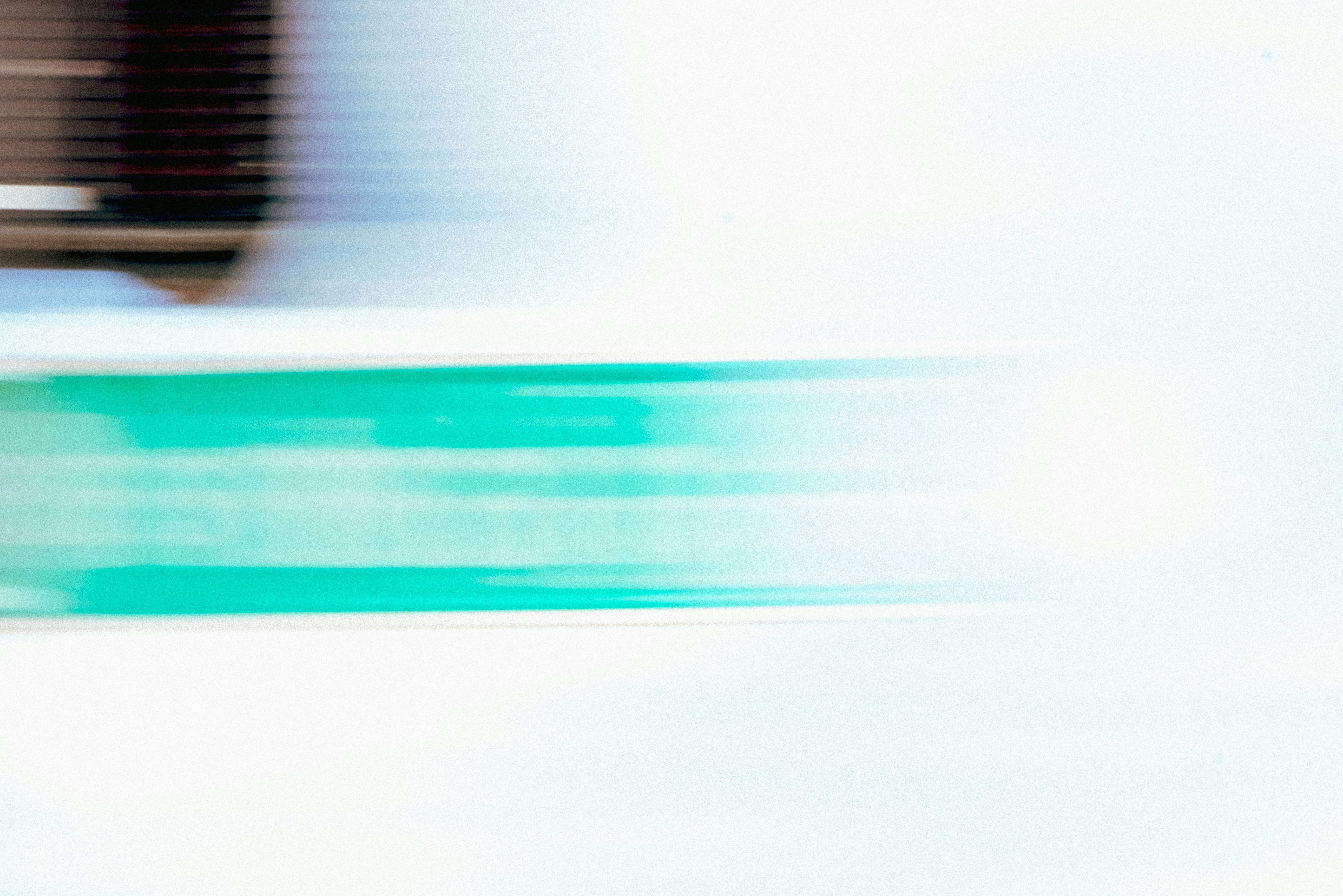 Abstract motion blur with teal and white streaks